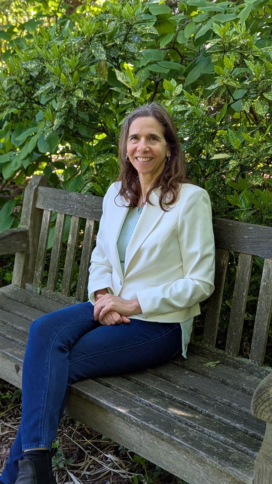 Rebecca Gotterer, a Montclair, NJ therapist, seated on a garden bench